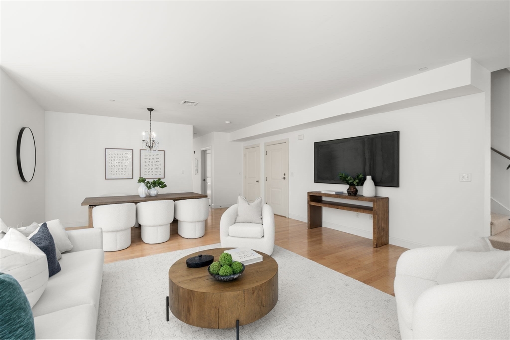 125 Crowninshield Road, Unit 125 Brookline, MA 02446 - Photo 5 of 22 a living room with furniture and a flat screen tv