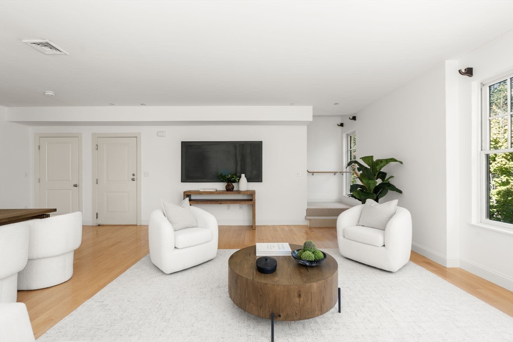 125 Crowninshield Road, Unit 125 Brookline, MA 02446 - Photo 6 of 22 a living room with furniture a flat screen tv and a potted plant