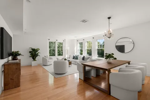 a living room with furniture a window and a chandelier