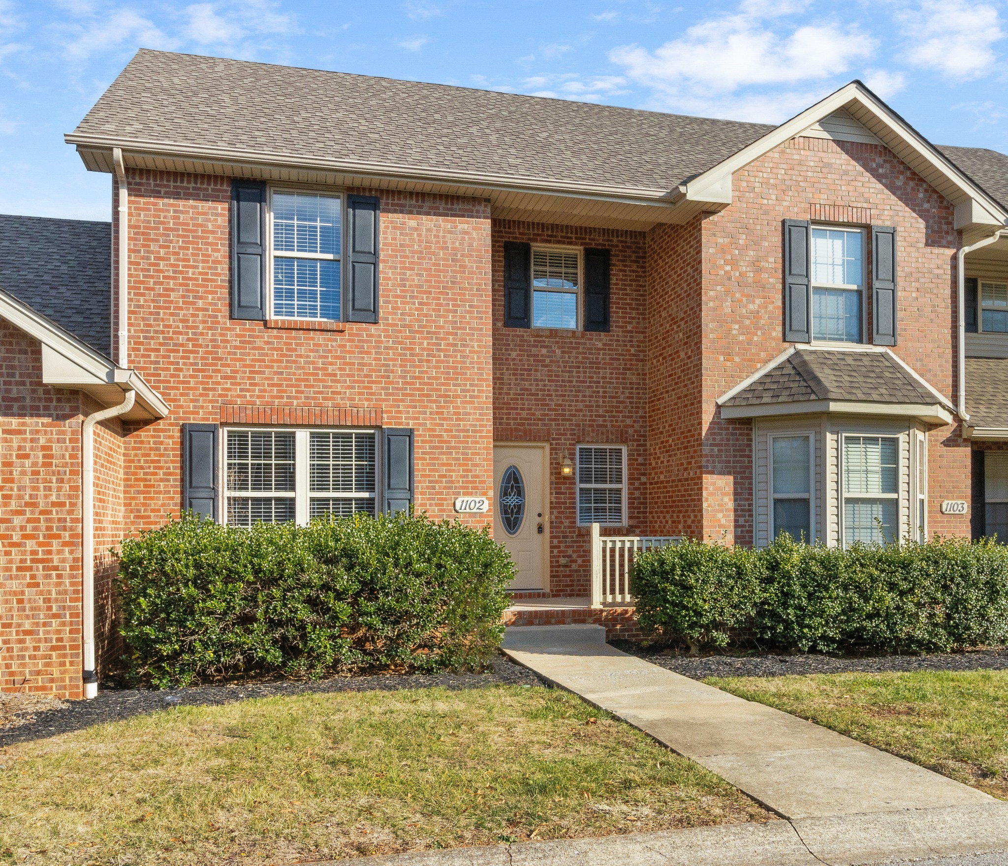 135 Excell Road, Unit 1102 Clarksville, TN 37043 - Photo 3 of 30 a front view of a house with garden