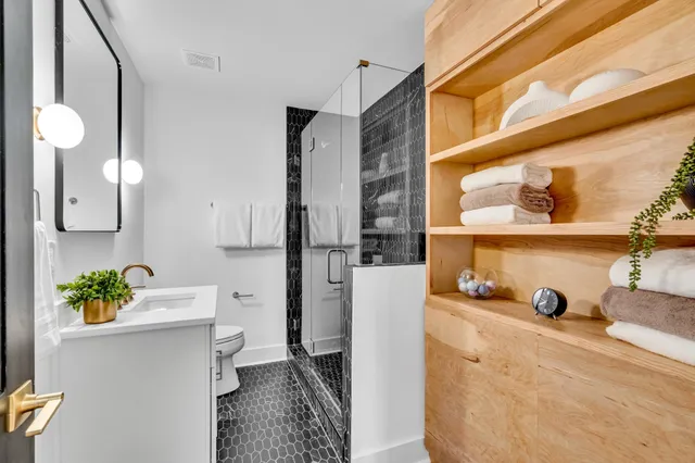 a white bath tub sitting next to a bathroom