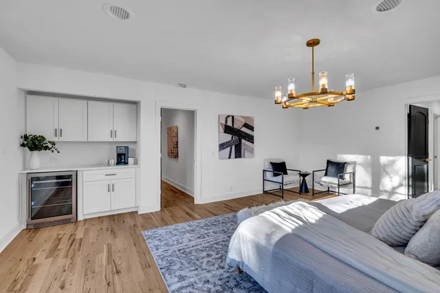 a bedroom with furniture and a chandelier