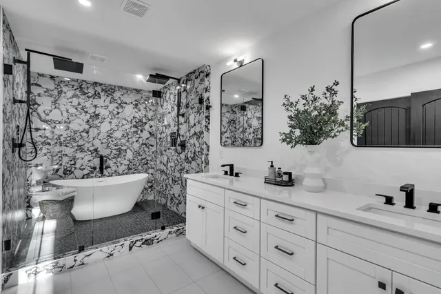 a bathroom with a double vanity sink mirror and toilet