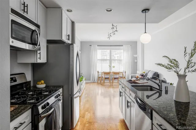 a view of a dining room with furniture and wooden floor