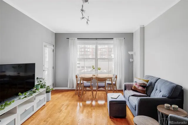 a dining room with furniture and wooden floor