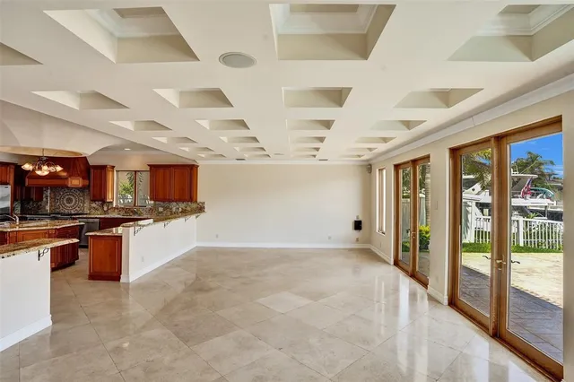a view of an empty room with glass door and balcony