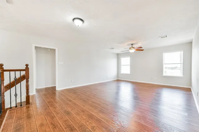 a view of a room with wooden floor and a window