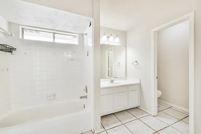 a bathroom with a mirror a sink and shower