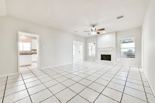 a view of an empty room with a fireplace