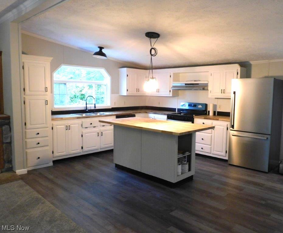 6045 Gore Road Ashtabula, OH 44004 - Photo 14 of 23 Kitchen with a kitchen island, range with electric stovetop, white cabinets, and stainless steel fridge