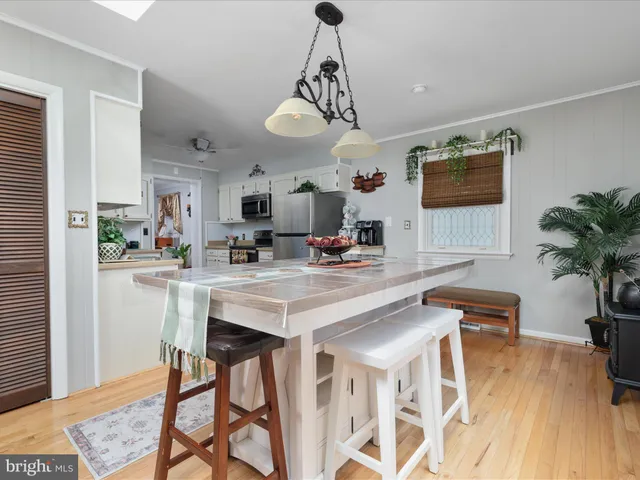 a view of a dining room with furniture and a chandelier