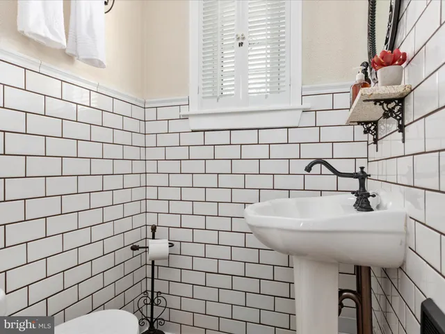 a bathroom with a sink toilet and mirror