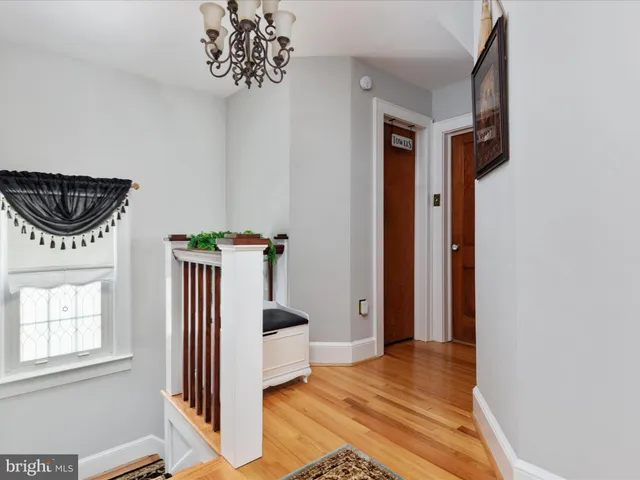 a view of a hallway with closet and front door