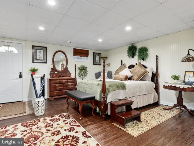 a bed room with a bed mirror and a window