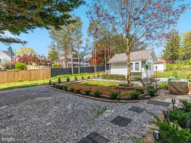 a view of a house with a backyard and tree s