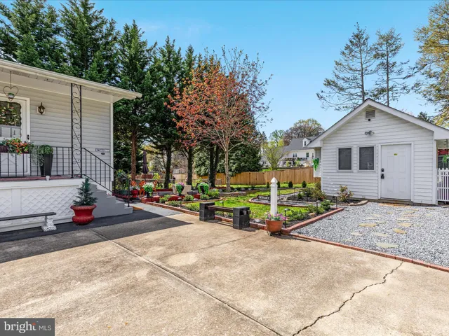 a front view of a house with a yard and outdoor seating