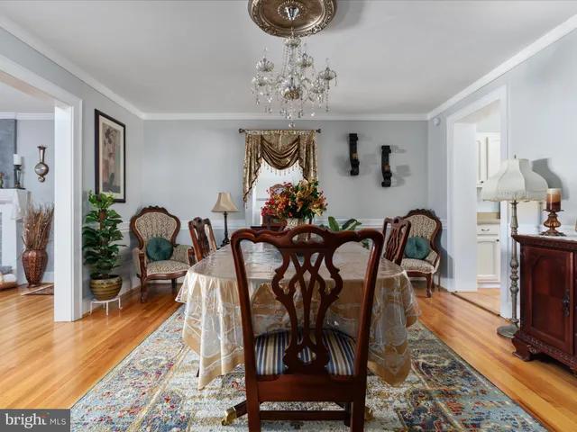 a view of a dining room with furniture wooden floor and chandelier