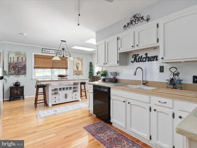 a kitchen with stainless steel appliances sink stove and cabinets