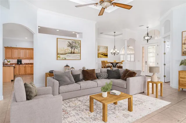 a living room with furniture and a potted plant