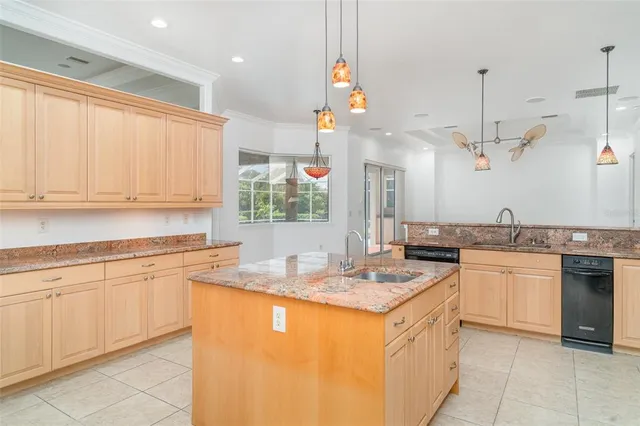 a view of an empty room with a fireplace and a ceiling fan