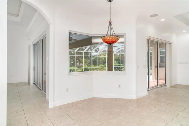 a view of a hallway with chandelier and livingroom