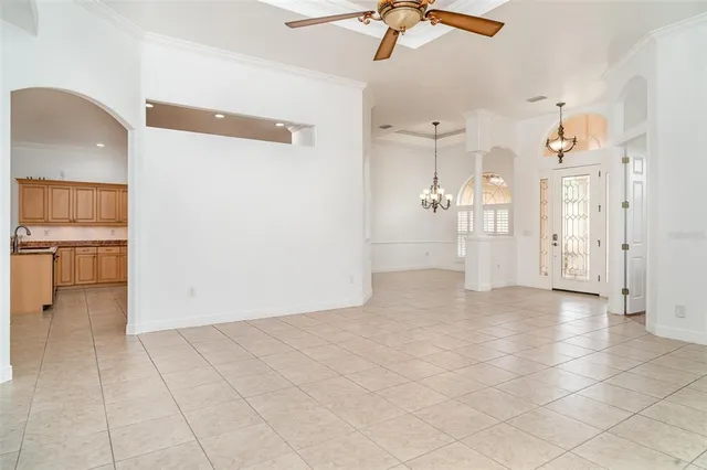 a living room with furniture a bed and a chandelier