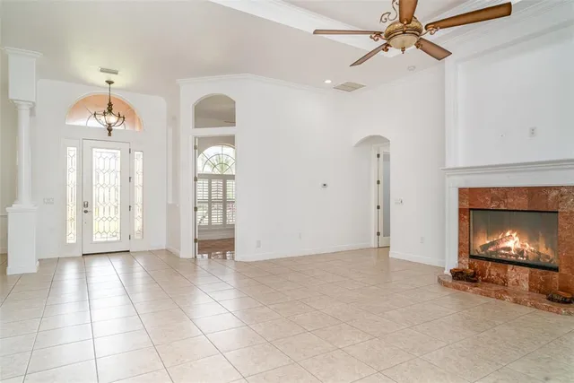 a spacious bedroom with a bed and a chandelier
