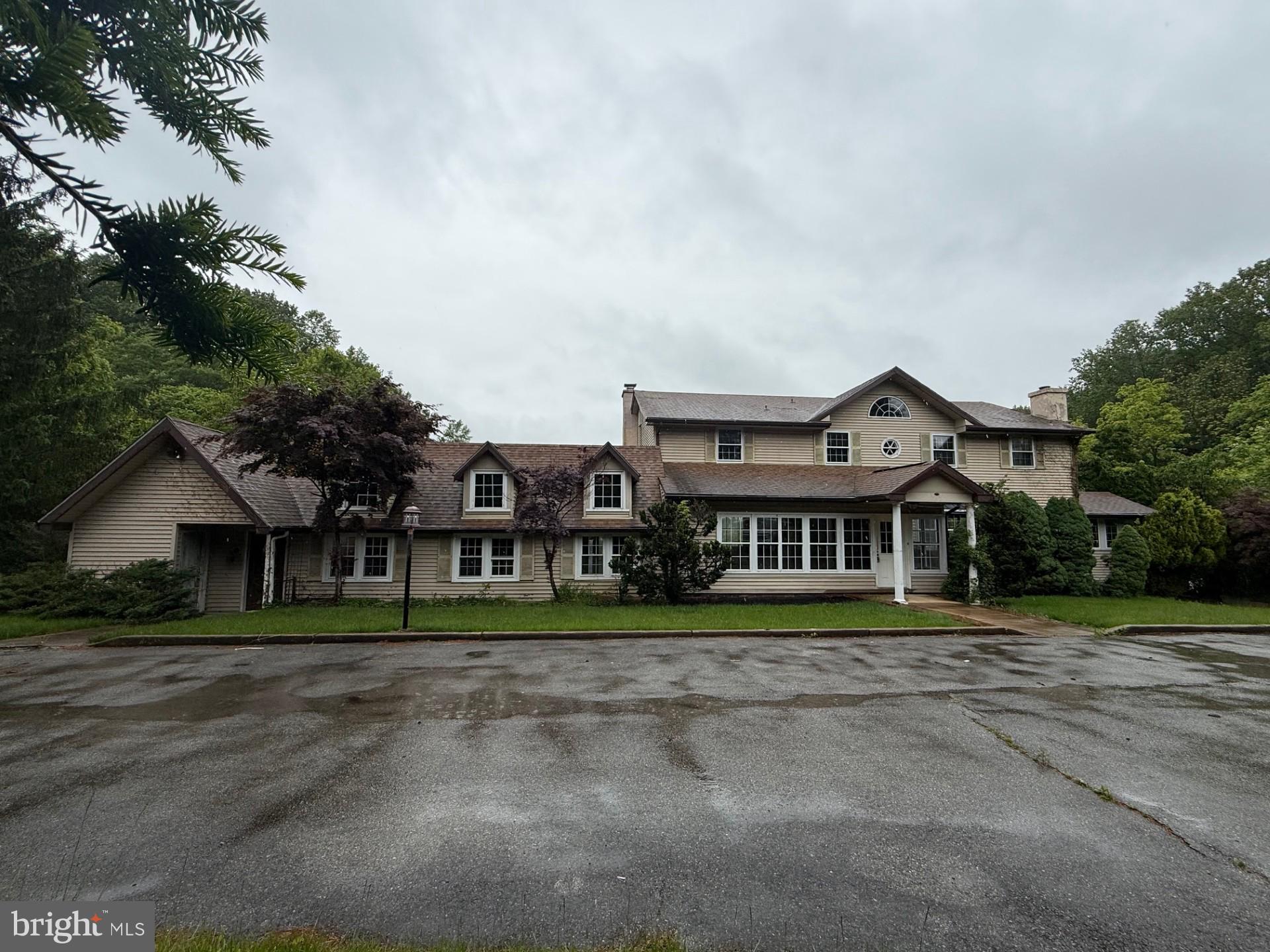 790 Hopewell Road Downingtown, PA 19335 - Photo 2 of 27 a front view of a house with a garden