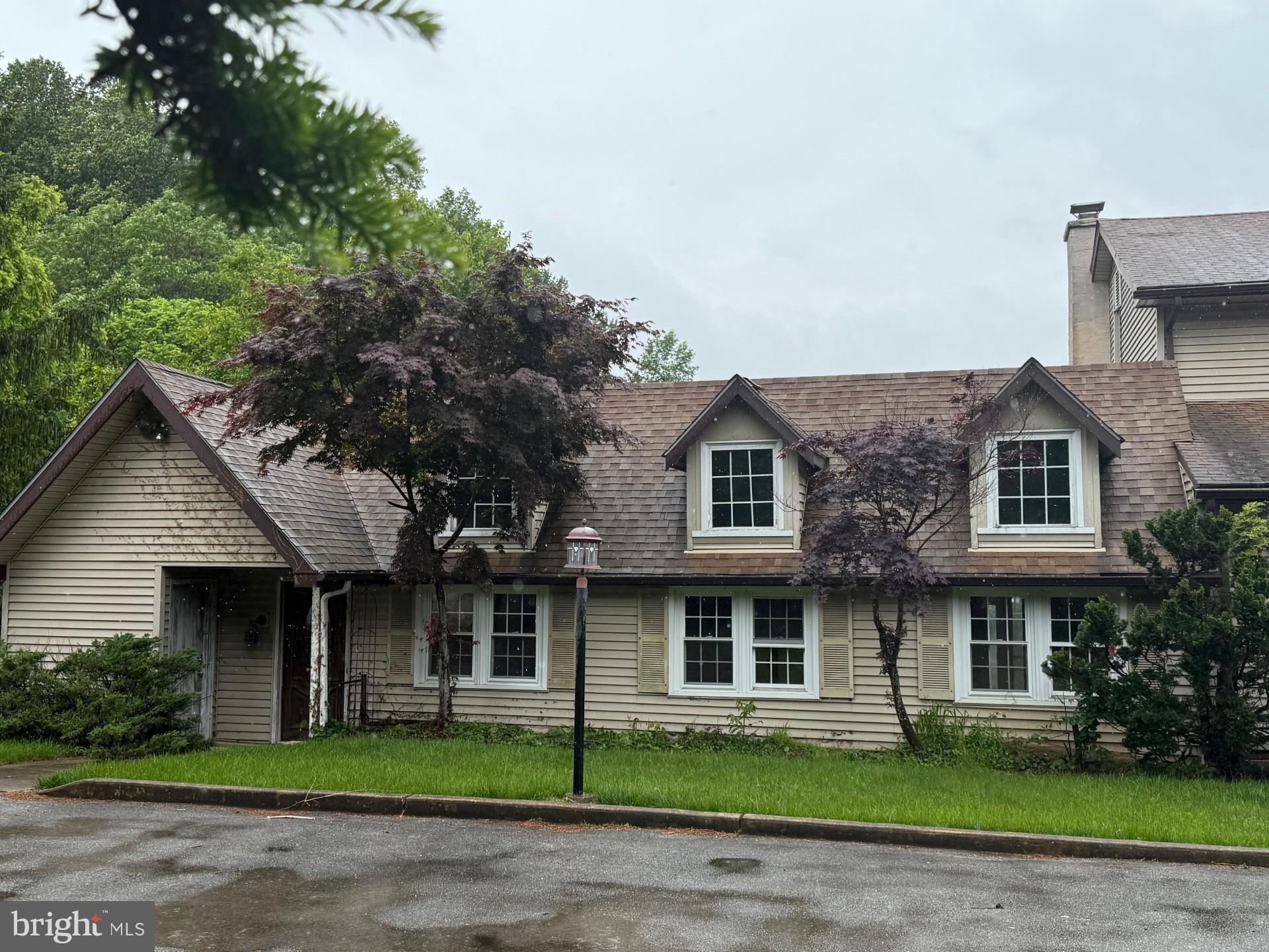 790 Hopewell Road Downingtown, PA 19335 - Photo 5 of 27 a front view of a house with a garden