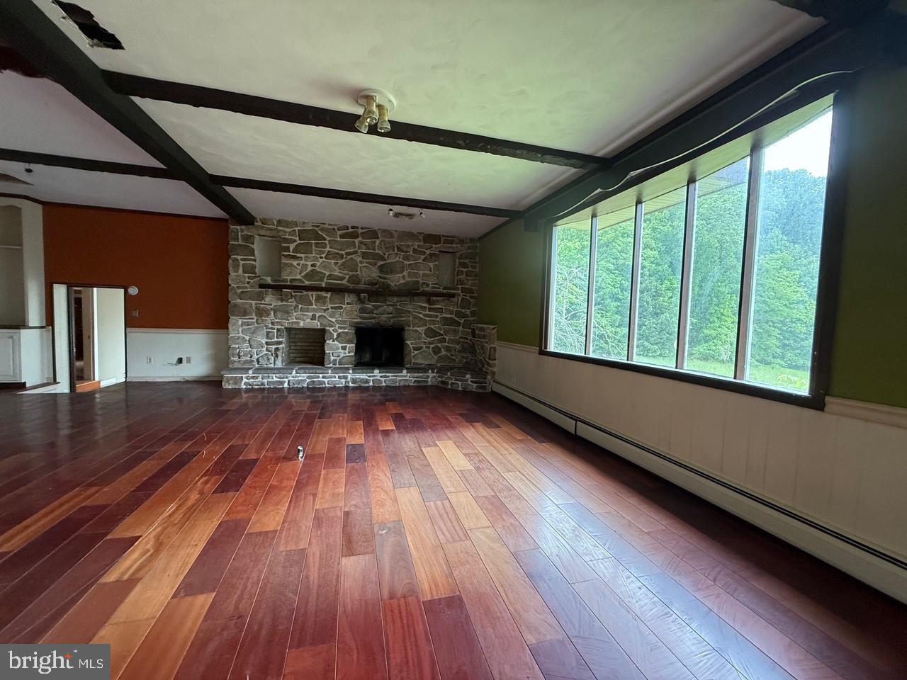 790 Hopewell Road Downingtown, PA 19335 - Photo 8 of 27 a view of empty room with wooden floor and fireplace