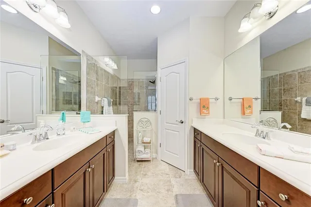 a spacious bathroom with a double vanity sink mirror and double