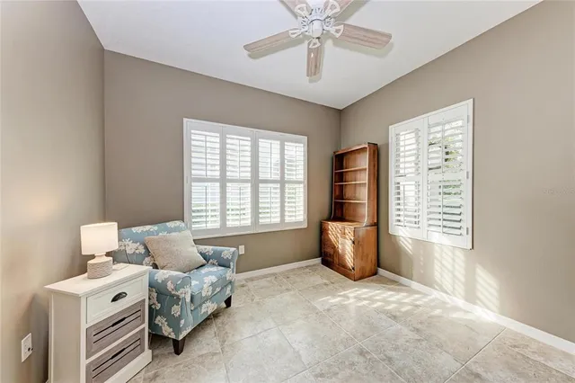 a spacious bedroom with a bed and a chandelier