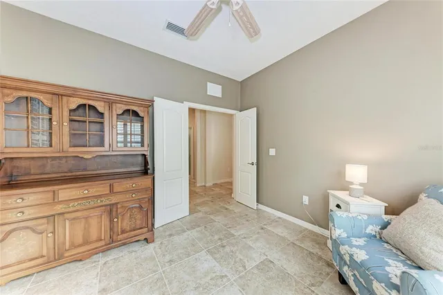 a spacious bedroom with a bed and a cabinets