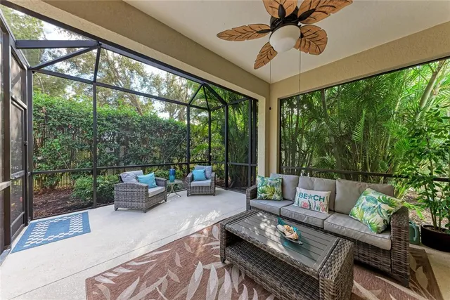 a living room with furniture and a floor to ceiling window