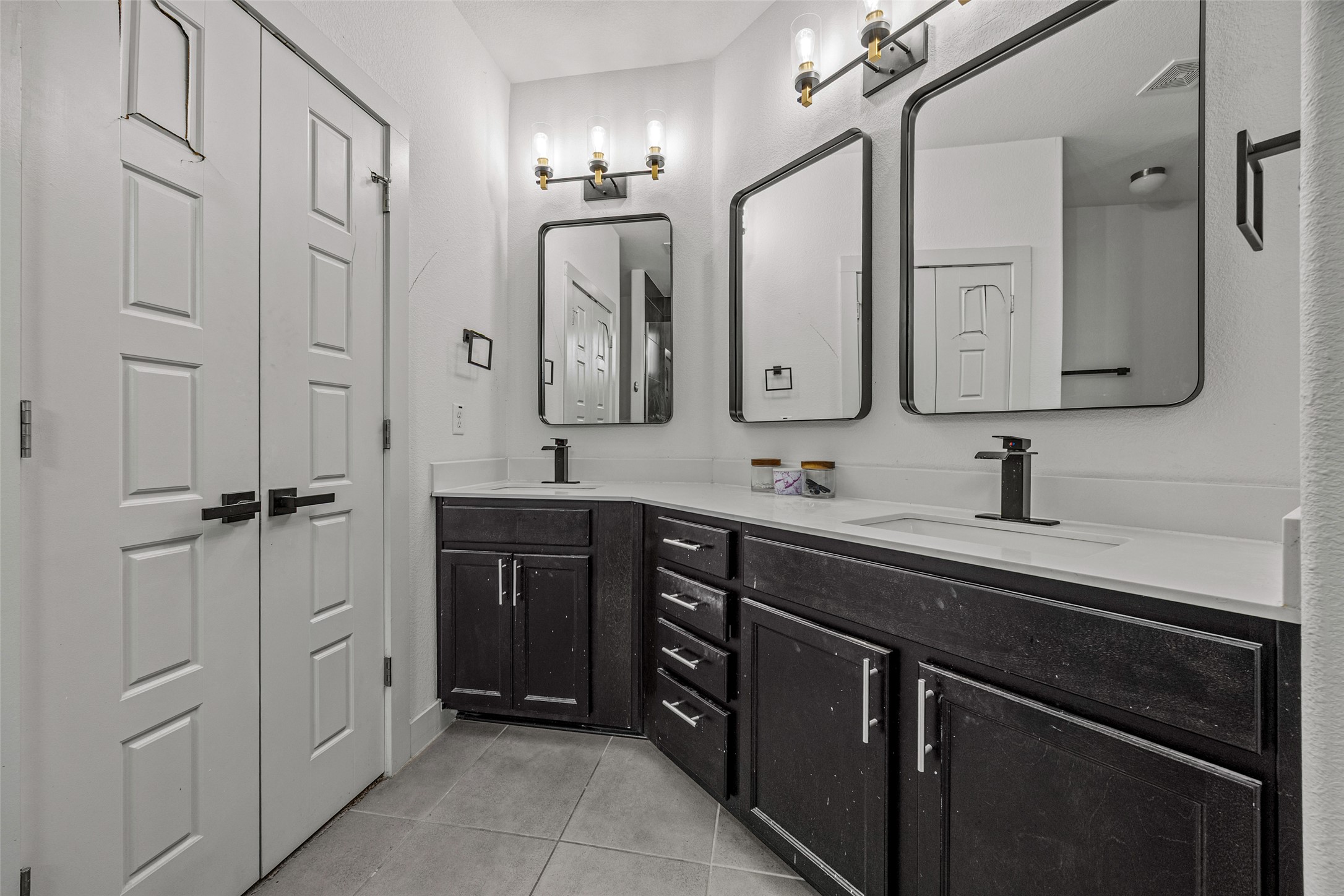 1408 Homespun Road Austin, TX 78745 - Photo 15 of 20 Dual vanities with sleek fixtures define this contemporary bathroom.
