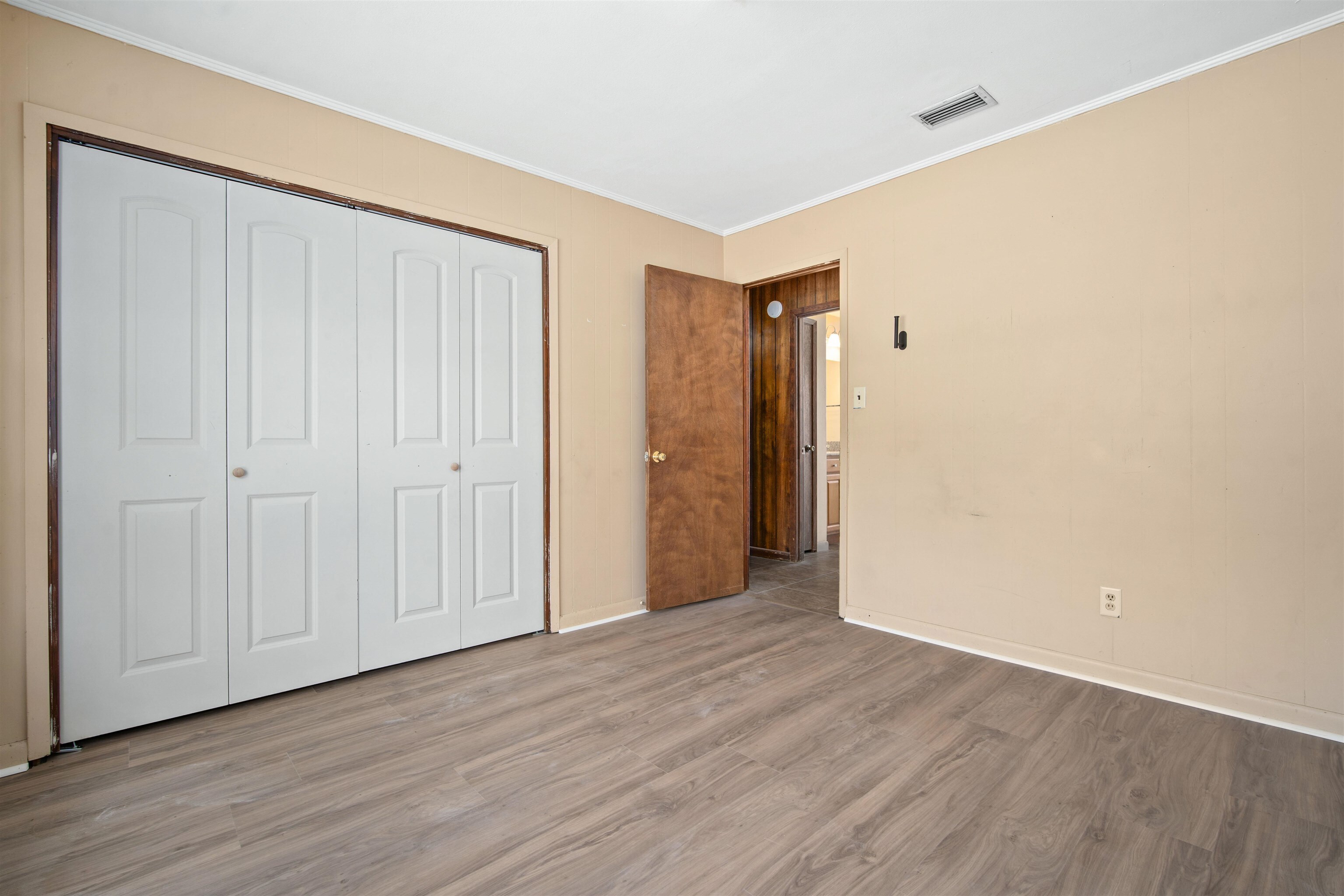 10285 Argyle Road Irvington, AL 36544 - Photo 23 of 28 Unfurnished bedroom featuring wood finished floors, crown molding, and a closet