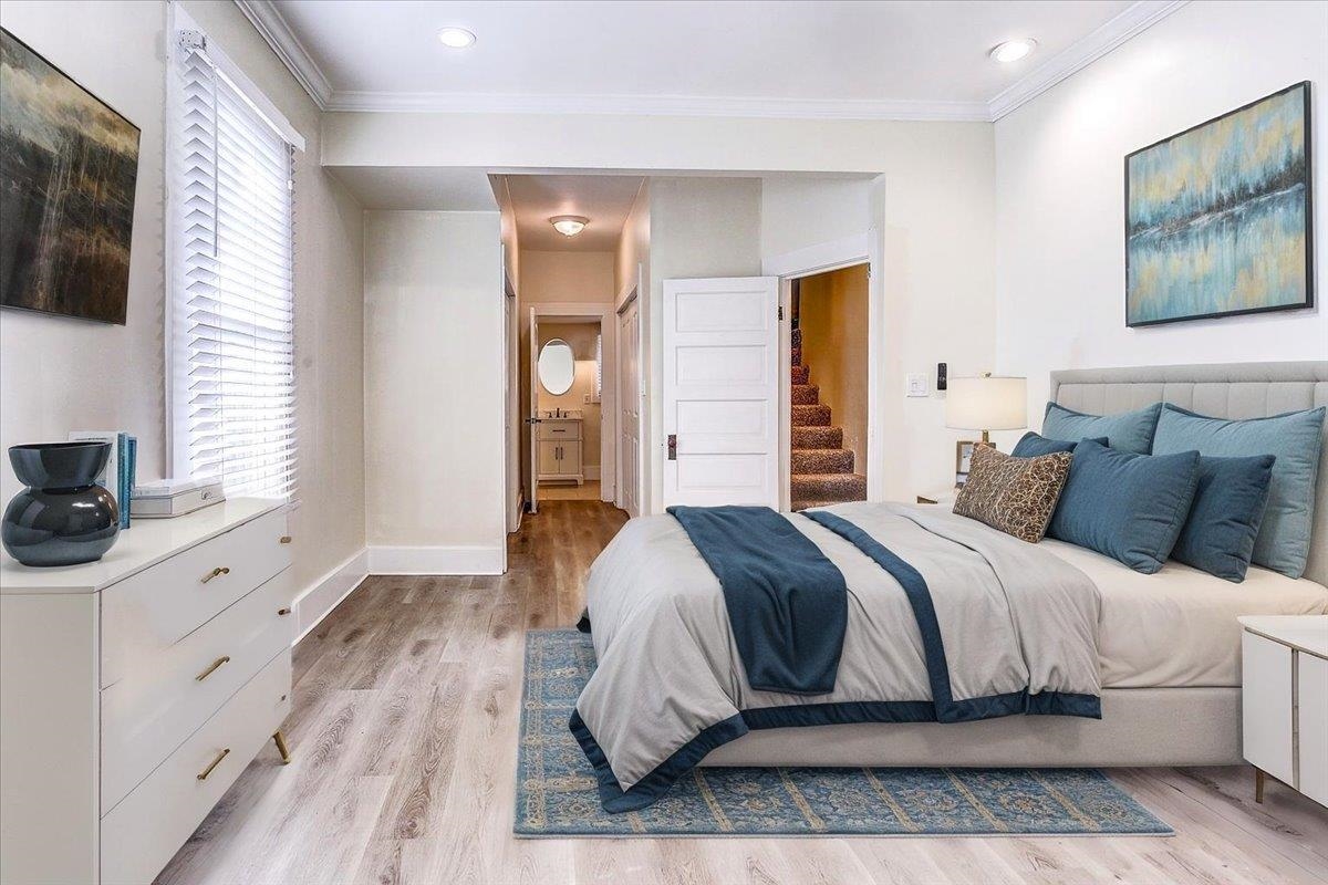 989 Bruce Street Memphis, TN 38104 - Photo 11 of 40 Bedroom with ensuite bath, ornamental molding, light wood-type flooring, and recessed lighting