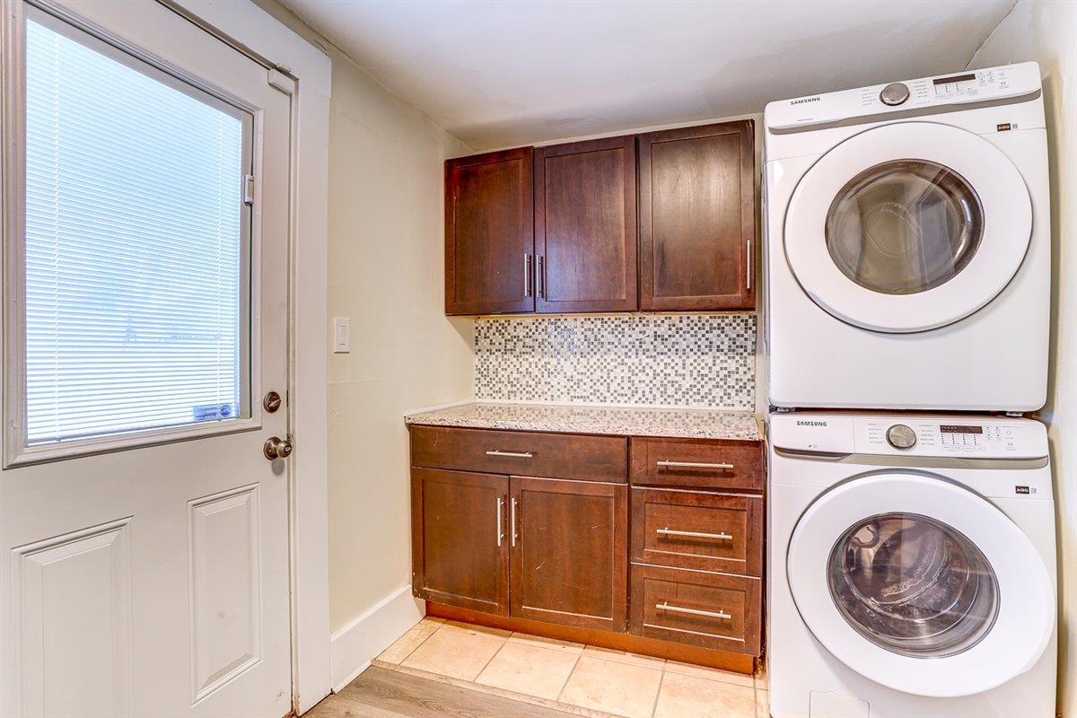 989 Bruce Street Memphis, TN 38104 - Photo 17 of 40 Washroom with stacked washer and clothes dryer and cabinet space
