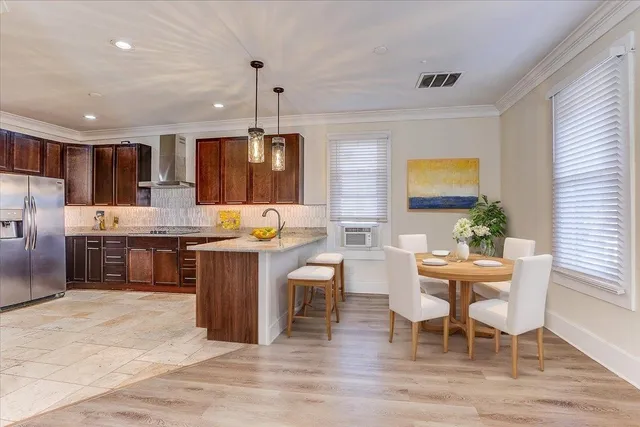 a kitchen with granite countertop white cabinets and stainless steel appliances