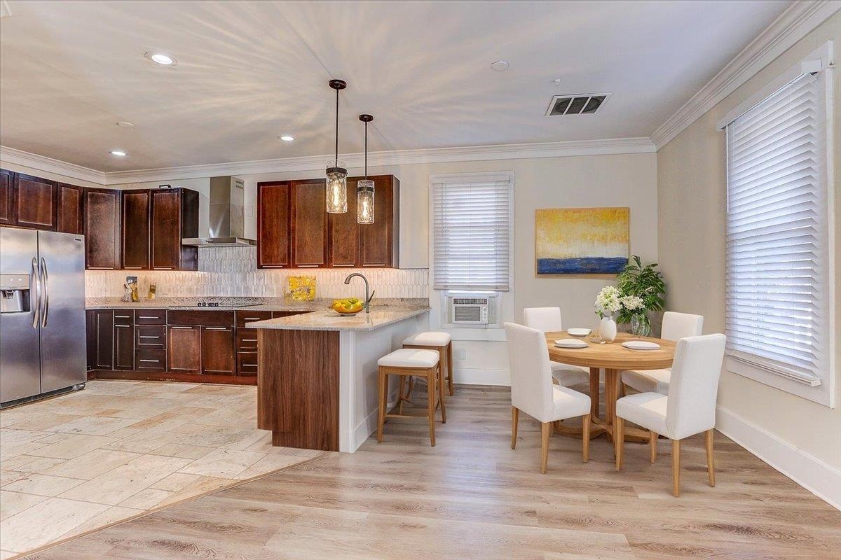 989 Bruce Street Memphis, TN 38104 - Photo 2 of 40 a kitchen with a table chairs sink and cabinets