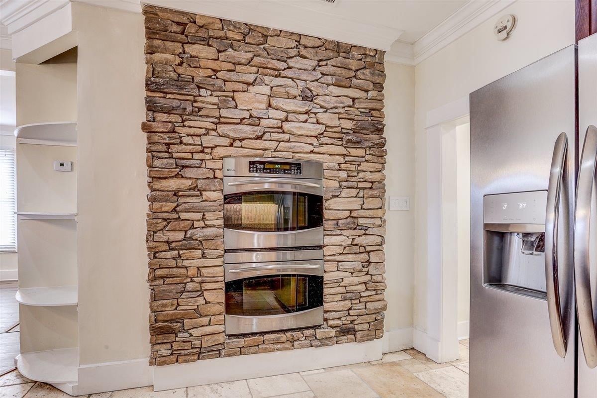 989 Bruce Street Memphis, TN 38104 - Photo 3 of 40 a kitchen with granite countertop white cabinets and stainless steel appliances