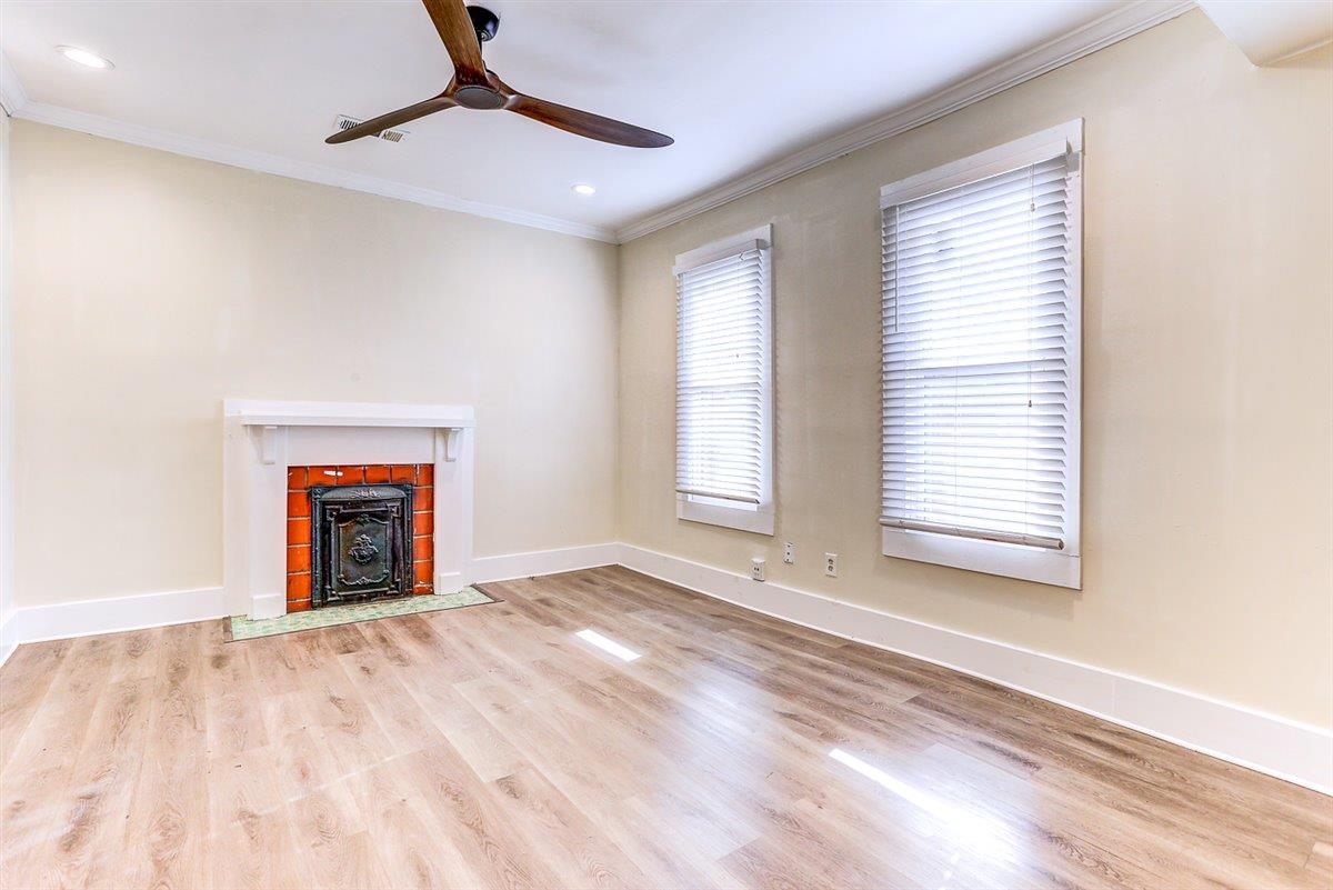 989 Bruce Street Memphis, TN 38104 - Photo 35 of 40 Unfurnished living room with light wood-style flooring, a ceiling fan, ornamental molding, and recessed lighting