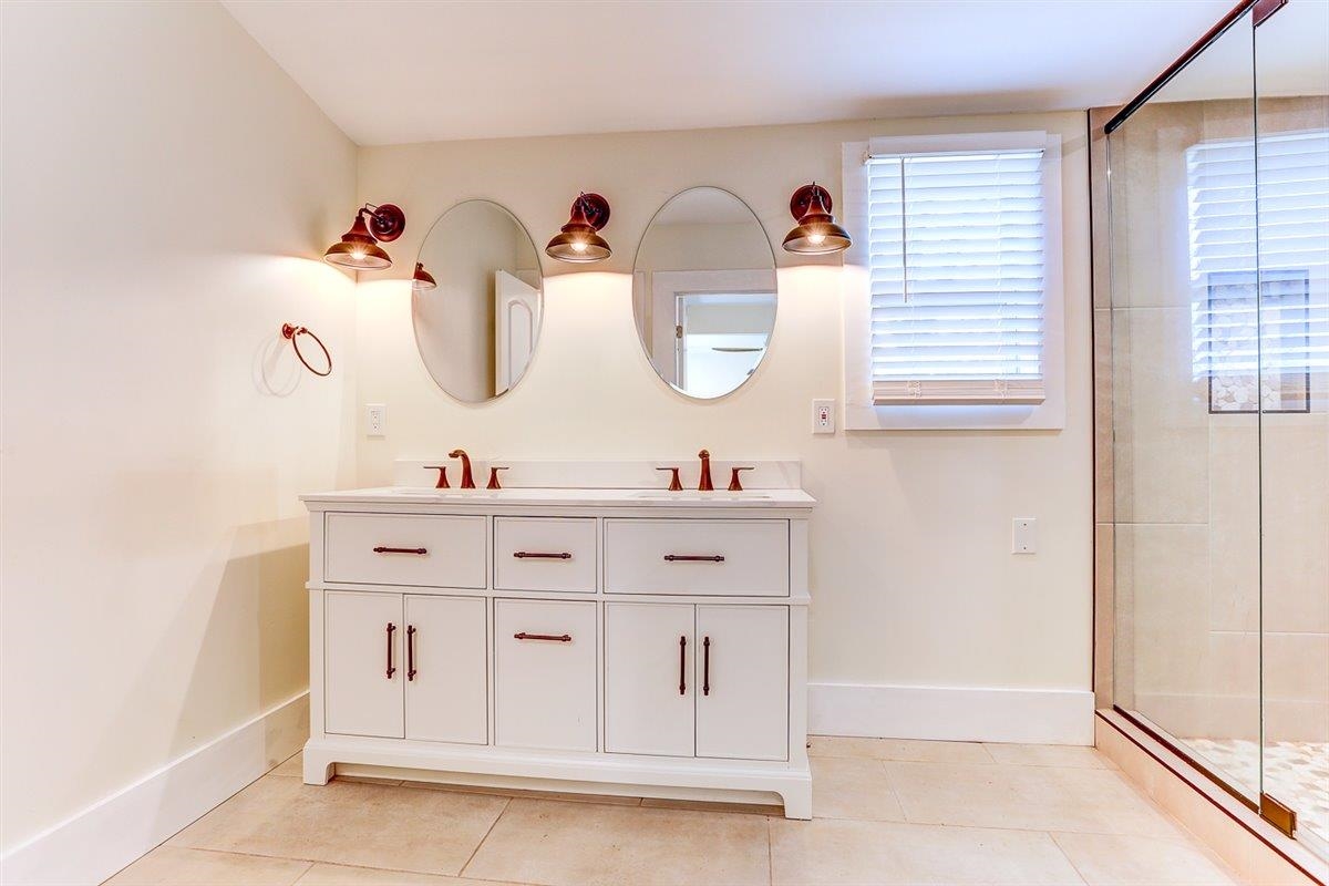 989 Bruce Street Memphis, TN 38104 - Photo 37 of 40 Bathroom featuring double vanity, a shower stall, and light tile patterned floors