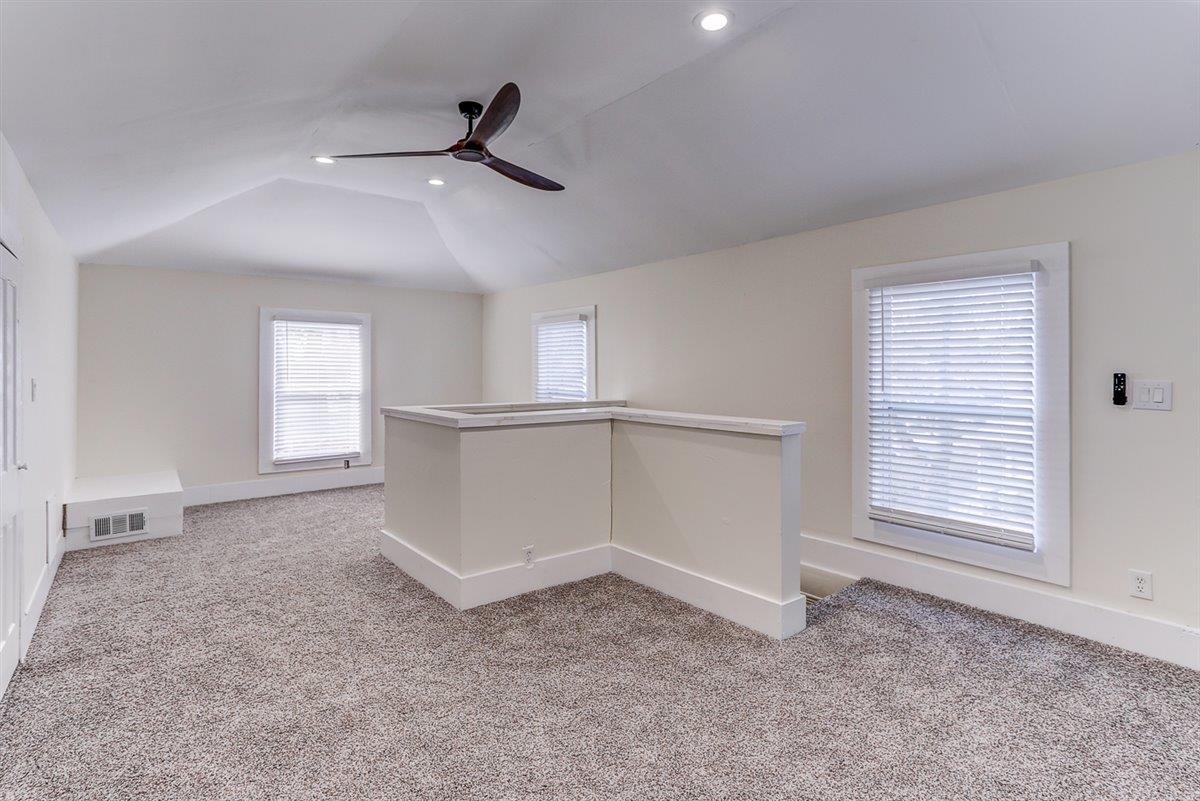 989 Bruce Street Memphis, TN 38104 - Photo 38 of 40 Spare room with light colored carpet, vaulted ceiling, a ceiling fan, and recessed lighting