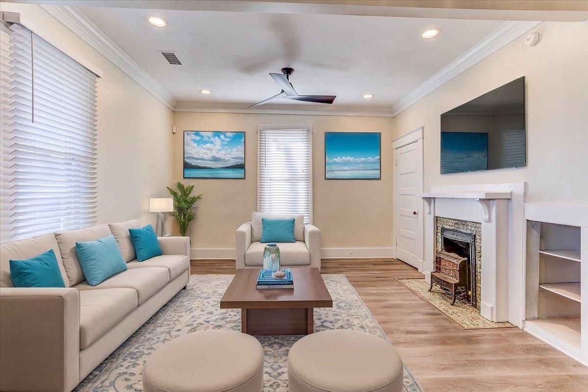 989 Bruce Street Memphis, TN 38104 - Photo 5 of 40 a living room with furniture a fireplace and a flat screen tv