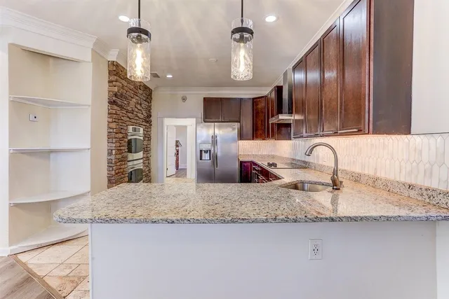 a kitchen with a refrigerator and a oven