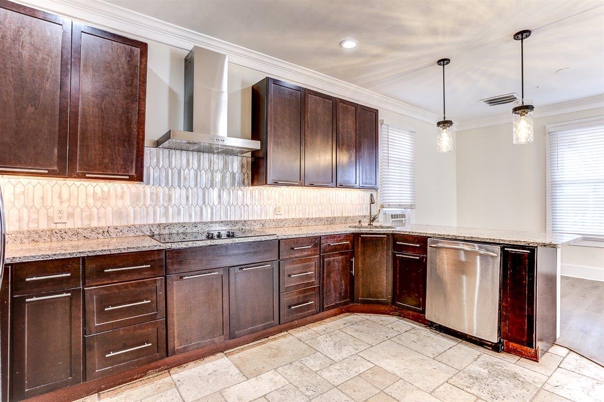 989 Bruce Street Memphis, TN 38104 - Photo 9 of 40 a kitchen with stainless steel appliances granite countertop a sink and stove