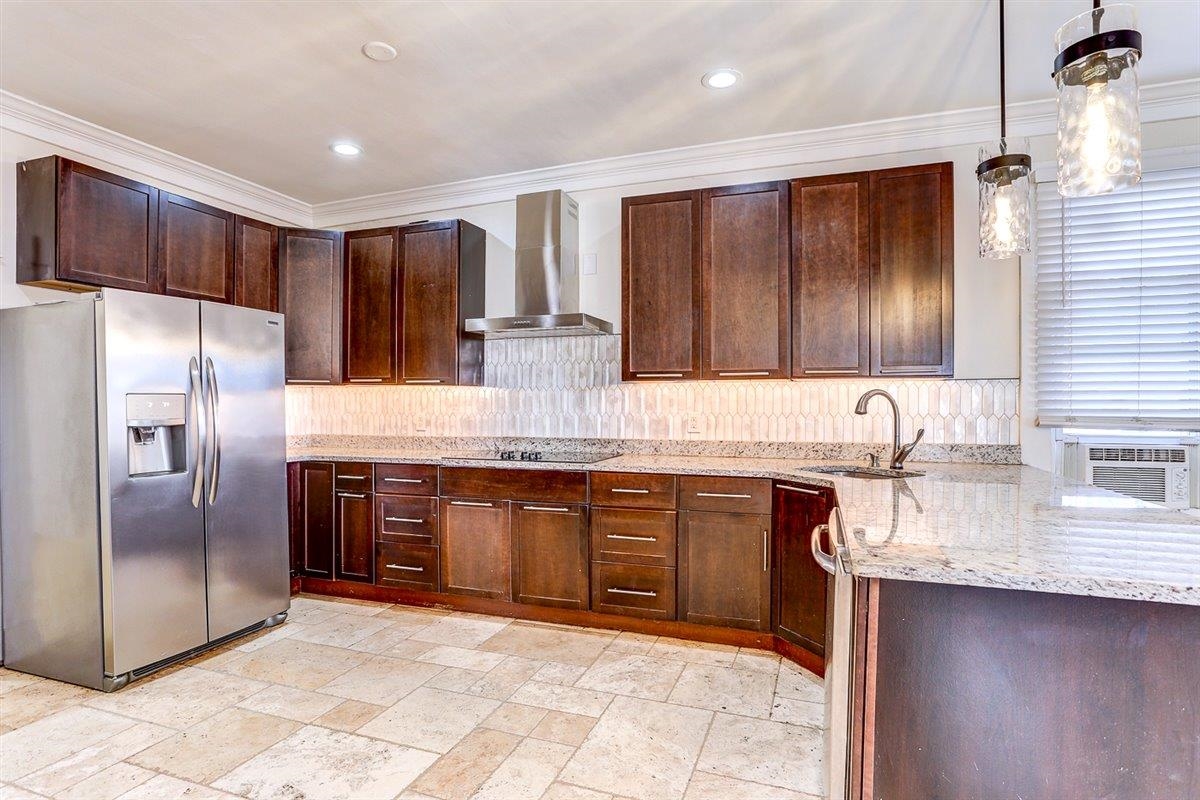 989 Bruce Street Memphis, TN 38104 - Photo 10 of 40 a kitchen with stainless steel appliances granite countertop a sink stove refrigerator and cabinets