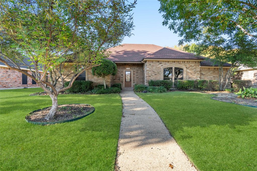 1106 Tahlequah Trail Carrollton, TX 75007 - Photo 1 of 20 a front view of a house with a yard