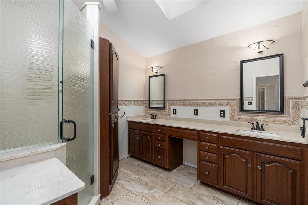 1106 Tahlequah Trail Carrollton, TX 75007 - Photo 12 of 20 a spacious bathroom with a double vanity sink a mirror and a shower